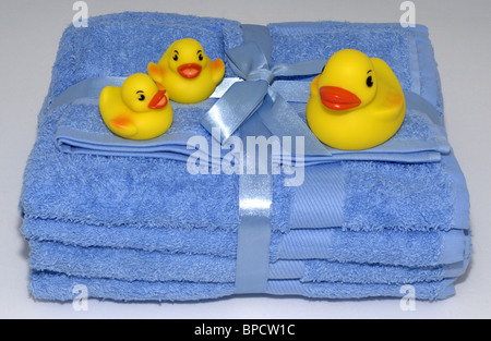 Rubber ducks on blue towels Stock Photo