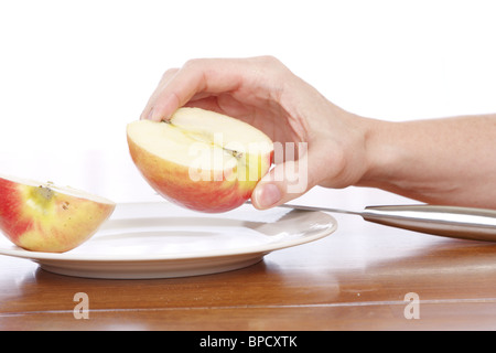 Hands slicing an apple Stock Photo