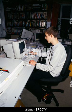 Work Experience 16 Year Old Boy Working On Computer In Office Stock
