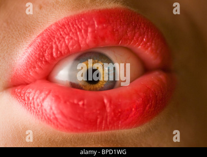 Close-up of eyeball inside mouth with pink lips Stock Photo