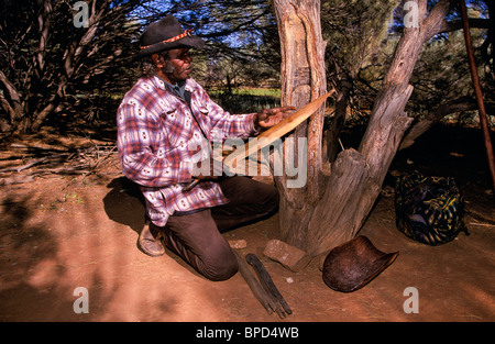 Carving spear thrower, outback Australia Stock Photo