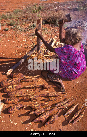 Senior Anangu woman preparing wood for carving, South Australia Stock Photo