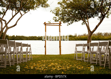Tranquil wedding setting with trellis, water and trees Stock Photo