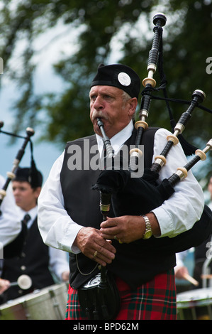 Scotsman playing the bagpipes at Stirling castle, Scotland Stock Photo