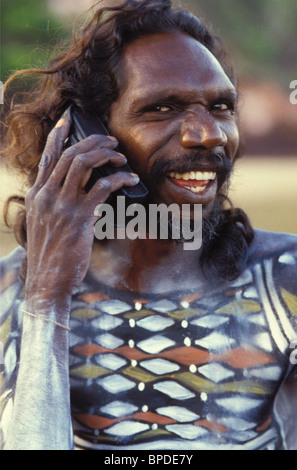 Aboriginal man from Arnhem Land playing part in 'Yolngu Boy' movie on his mobile phone Stock Photo