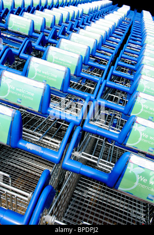 Several shoppings trolleys parked up in a line outside a Tesco supermarket Stock Photo