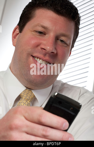 2010 vintage image of a businessman using a now outdated PDA, USA Stock Photo