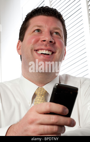 2010 vintage image of a businessman using a now outdated PDA, USA Stock Photo