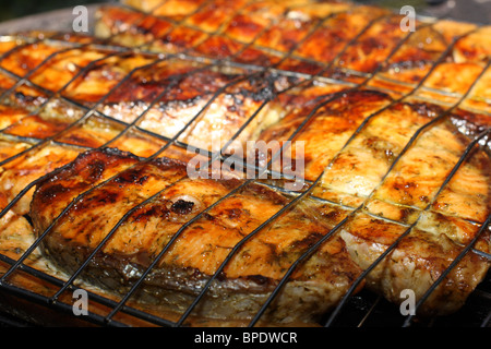 Salmon cooking on grill. Shallow DOF Stock Photo