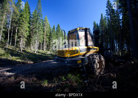 Finnish Ponsse Elk forest forwarder in spruce ( fir tree ) taiga forest at Summer , Finland Stock Photo