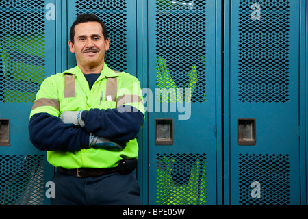 Hispanic sanitation worker in locker room Stock Photo