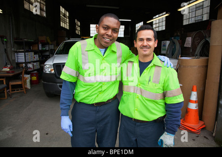 Sanitation workers in garage Stock Photo
