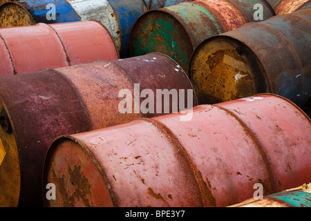 Empty rusting metal oil barrels in an abandoned factory site, Glasgow, Scotland Stock Photo