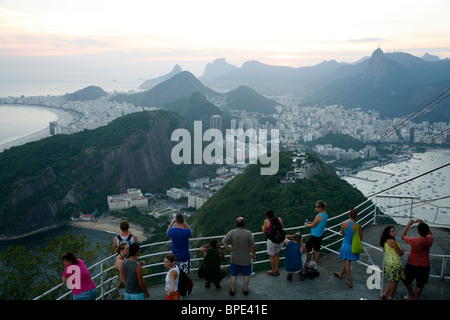 People on top of the Pao Asucar or Sugar loaf mountain with a view over the city, Rio de Janeiro, Brazil. Stock Photo