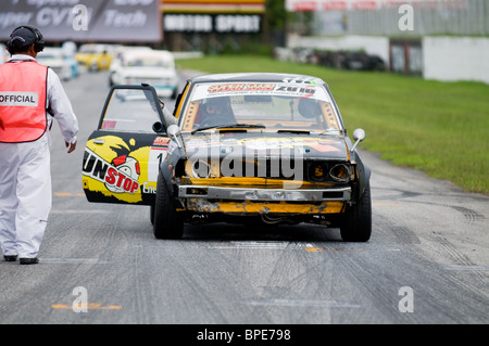 Shabby, old Toyota Corolla at the starting grid of a classic car race on Bira Circuit, Pattaya, Thailand. Stock Photo