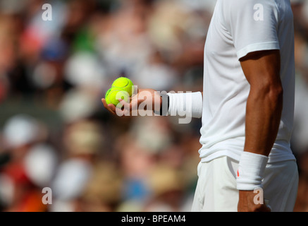 Rafael Nadal (ESP) taking a close look at two balls in his hand Stock Photo