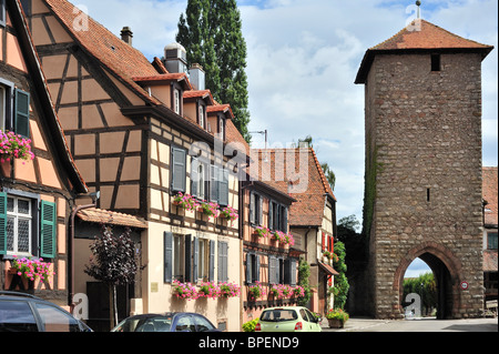 Town gate and colorful façades of timber framed houses at Dambach-la-Ville, Alsace, France Stock Photo