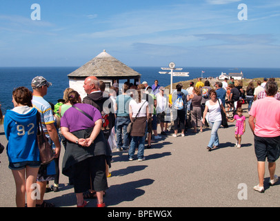 Queue of people to get photo taken in front of sign post at Land's End, Cornwall, UK Stock Photo