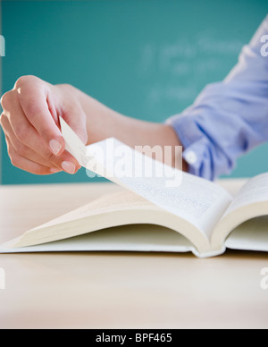 Hand turning page in book Stock Photo