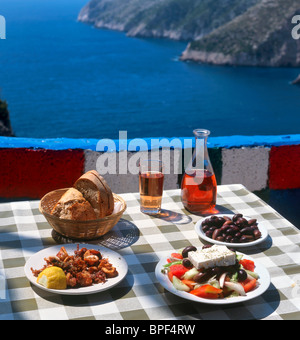 Greek food and wine at a taverna in Kambi, Zakynthos (Zante), Ionian Islands, Greece Stock Photo