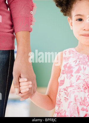 Woman and girl holding hands
