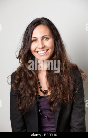 charming woman in black blazer and brim hat looking at camera isolated ...