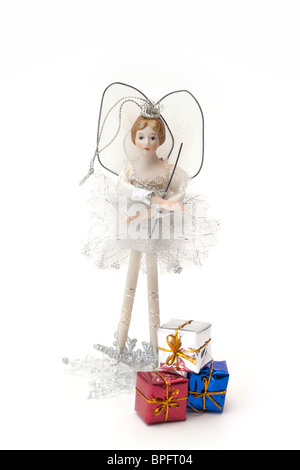 Pretty white and silver treetop fairy Christmas ornament with small foil wrapped boxes on a white background Stock Photo