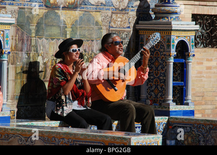 Buskers sitting on a tiled bench in the Plaza de Espana, Seville, Seville Province, Andalucia, Spain, Western Europe. Stock Photo