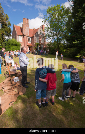 Children compete in the three legged race at a village fete in Weston , Suffolk , England , Great Britain , Uk Stock Photo