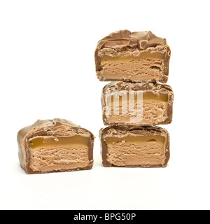 Abstract pile of Chocolate Caramel Bar sliced up isolated on white. Stock Photo