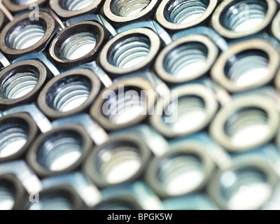 screw bolts on reflective white surface. Horizontal shape, selective focus Stock Photo