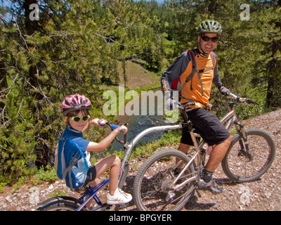 Man and child riding bikes. Stock Photo