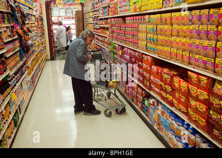 Elderly shopper in a supermarket in the New York borough of the Bronx Stock Photo