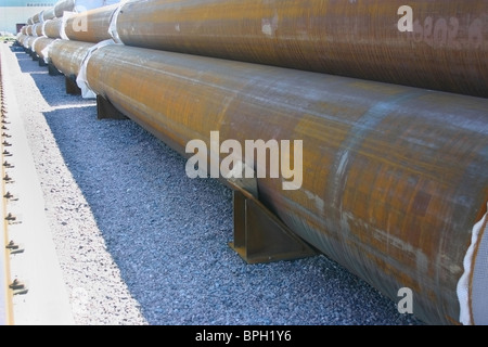 Big diameter ferrous metal pipes are on the storage yard. Stock Photo