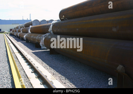 Big diameter ferrous metal pipes are on the storage yard. Stock Photo