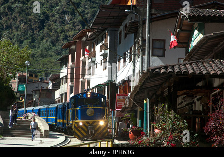 A train runs through the town of Aguas Calientes, (Machu Picchu Pueblo), Sacred Valley, Peru. Stock Photo