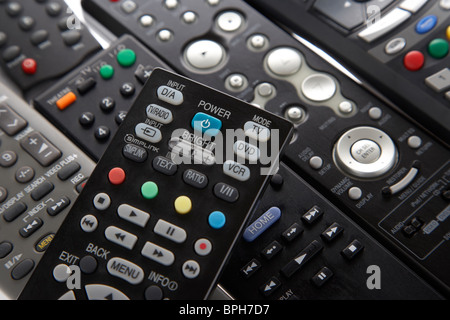 large selection of household remote controls used to control tv video hifi dvd blu ray player amp home entertainment many Stock Photo