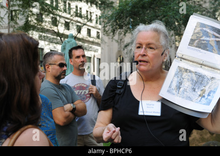 A  guide at the grave of Alexander Hamilton in Trinity Churchyard, Lower Manhattan,  talking to a tour group. Stock Photo