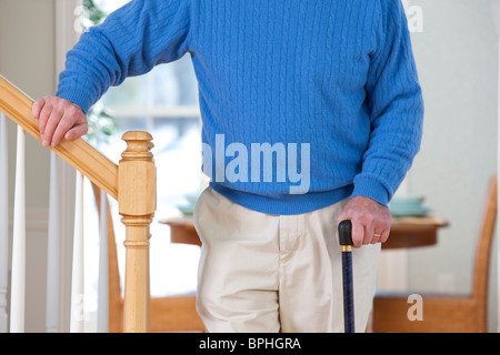 Man suffering from Parkinson's disease and multiple sclerosis standing near steps Stock Photo