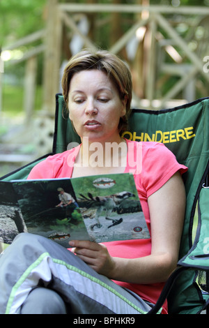 Woman Camping Reading Event Calendar Stock Photo
