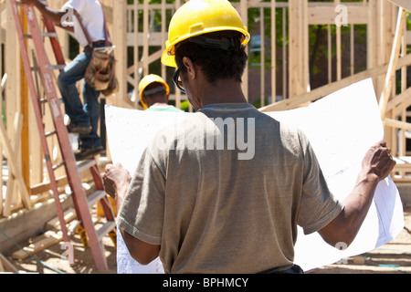 Construction manager reading a blueprint Stock Photo