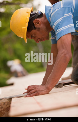 Carpenter doing measurements using triangle Stock Photo
