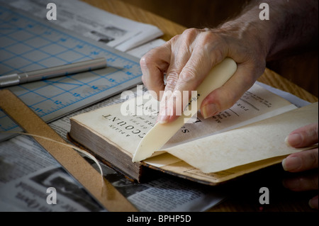 Old Man Hands Bookbinder Repairing An Old Book, Pennsylvania, USA Stock Photo