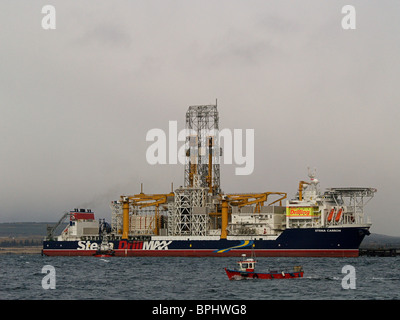 The Stena Carron Oil Drill Ship at the Nigg Oil Terminal, Cromarty Firth Scotland, with a local fishing boat in the foreground. Stock Photo