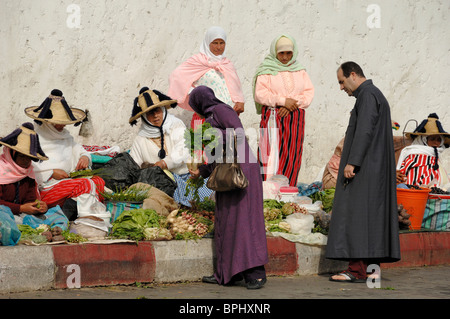 Moroccan Middle-Class Couple Shopping at Vegetable Market run by Rif Mountain Peasant Women, Tangier Tanger or Tangiers, Morocco Stock Photo