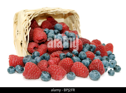 Fresh, juicy raspberries, blueberries and wicker basket, isolated on white background. Stock Photo