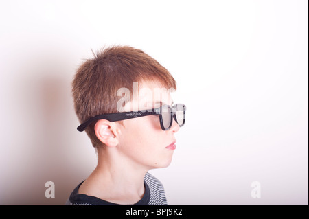 A MODEL RELEASED picture of a 10 year old boy wearing a pair of real 3d glasses in the studio Stock Photo
