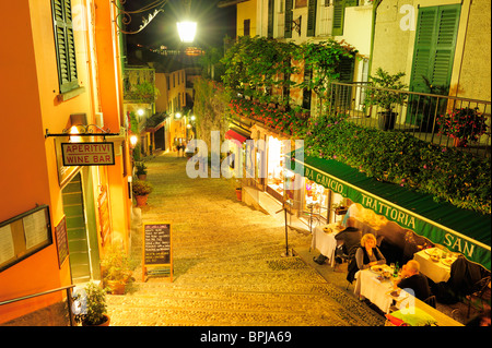 Illuminated alley with restaurants, Bellagio, Lake Como, Lombardy, Italy Stock Photo
