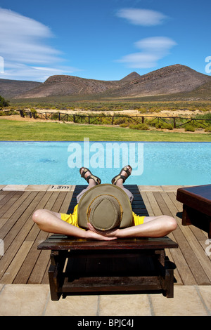 Man relaxing by the pool, Aquila Lodge, Cape Town, Western Cape, South Africa, Africa Stock Photo