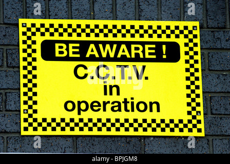 Close up of 'CCTV in operation' sign on wall Stock Photo